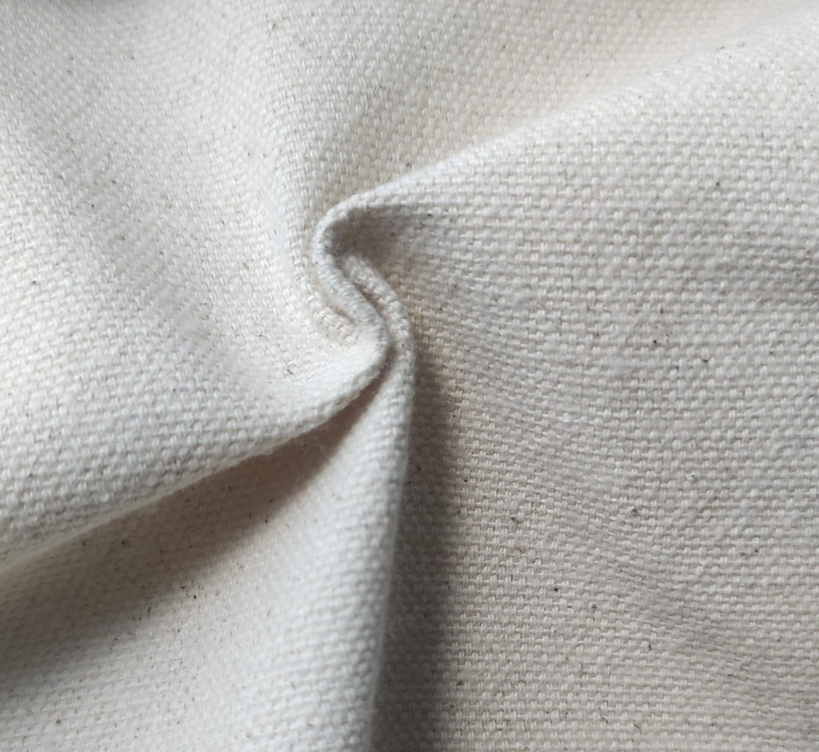 Close-up of soft, wrinkled pink cotton fabric displaying fine weave texture.