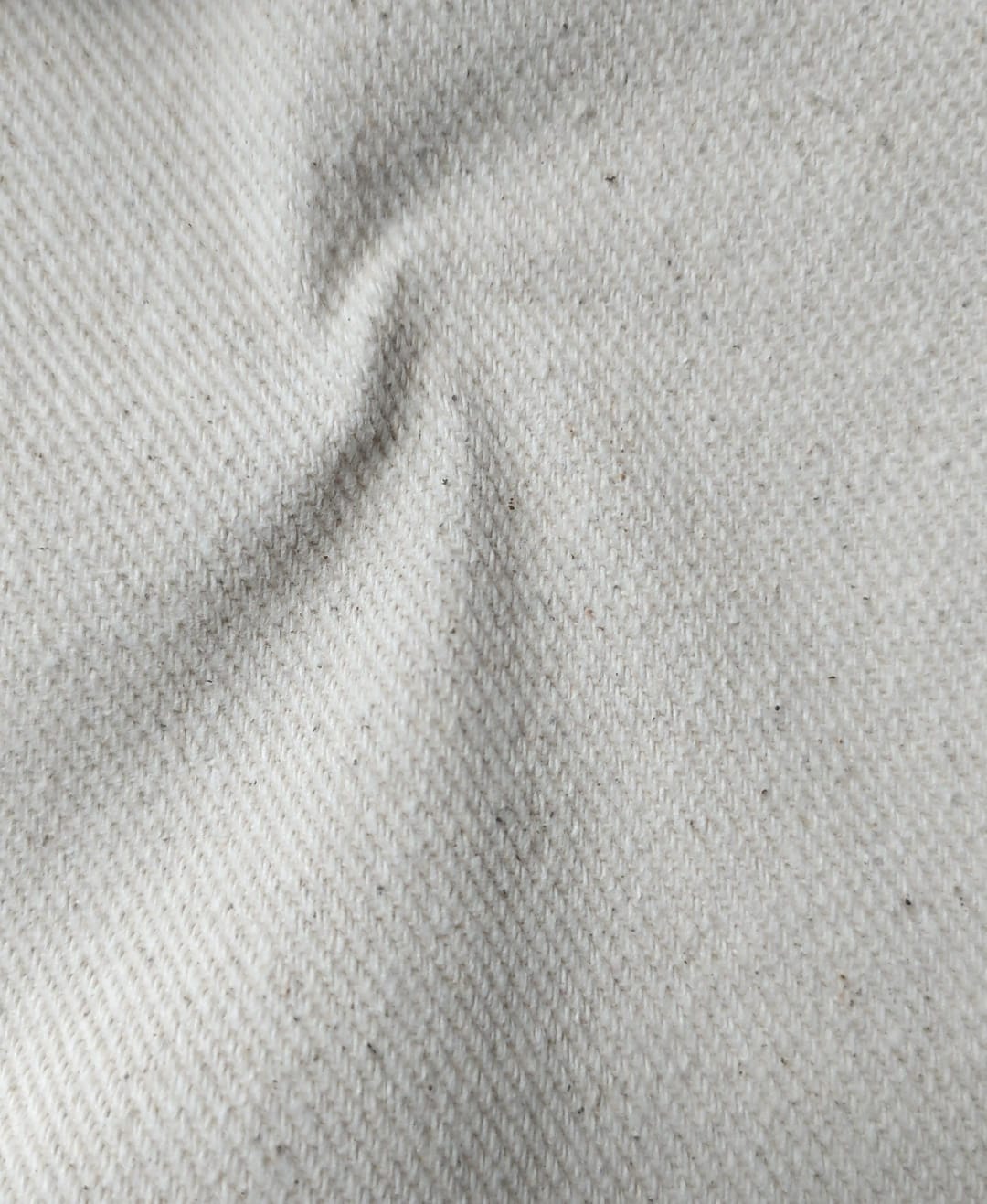 Close-up of soft, wrinkled pink cotton fabric displaying fine weave texture.