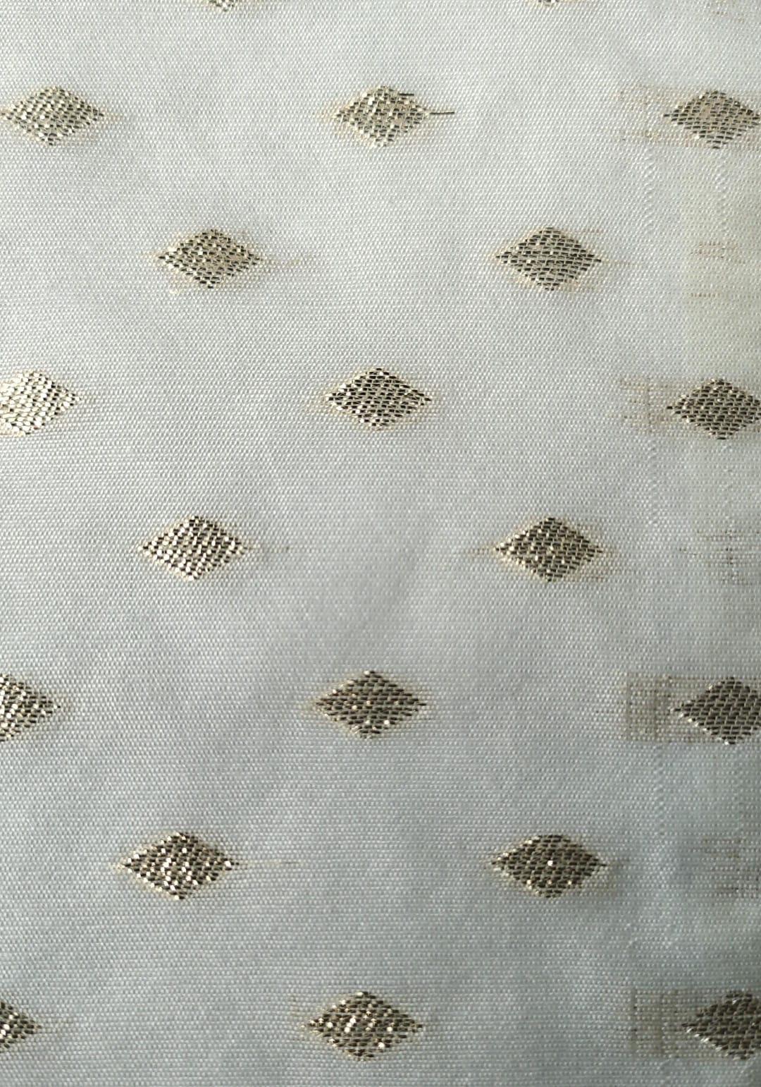 Close-up of soft, wrinkled pink cotton fabric displaying fine weave texture.