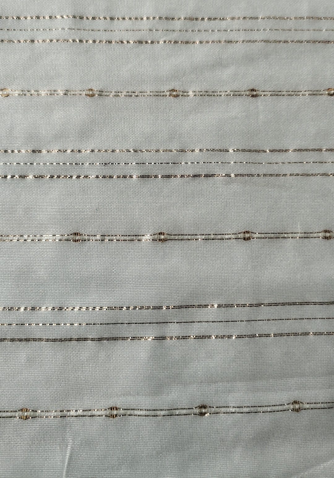 Close-up of soft, wrinkled pink cotton fabric displaying fine weave texture.