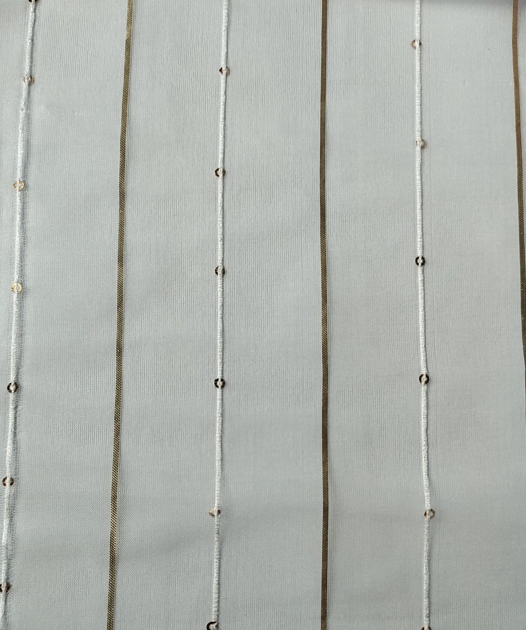 Close-up of soft, wrinkled pink cotton fabric displaying fine weave texture.