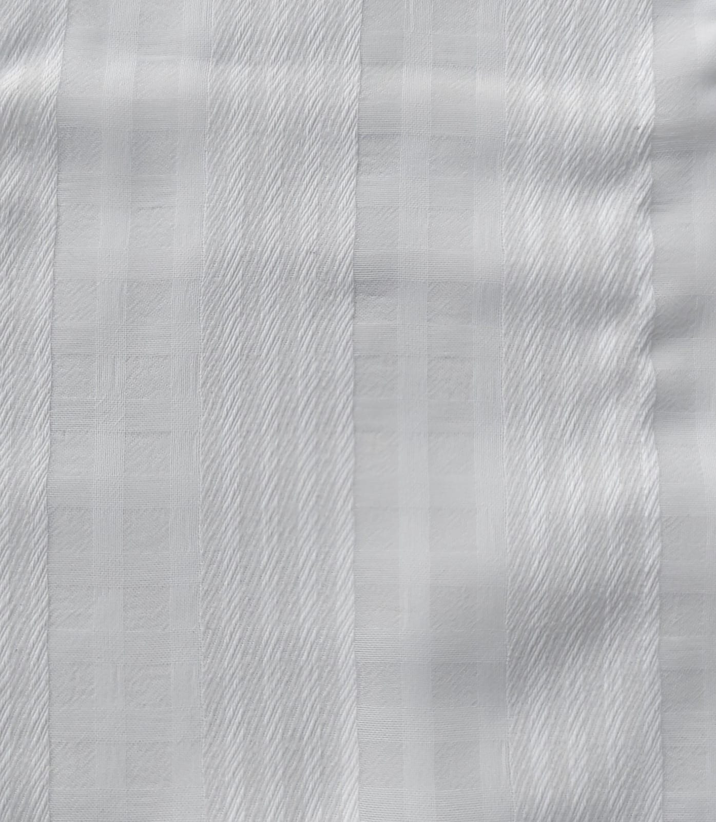 Close-up of soft, wrinkled pink cotton fabric displaying fine weave texture.