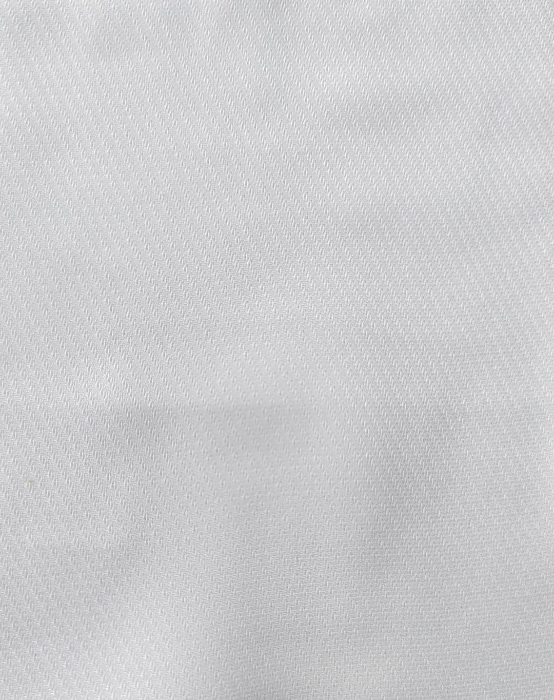 Close-up of soft, wrinkled pink cotton fabric displaying fine weave texture.