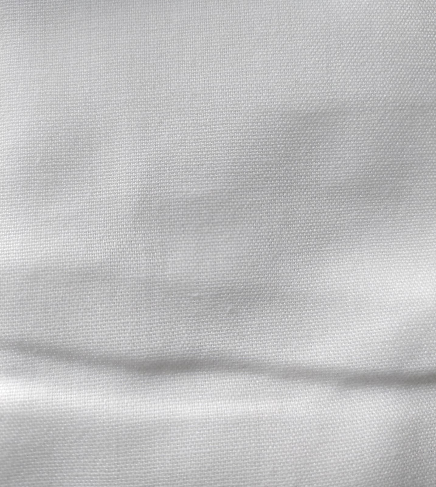 Close-up of soft, wrinkled pink cotton fabric displaying fine weave texture.