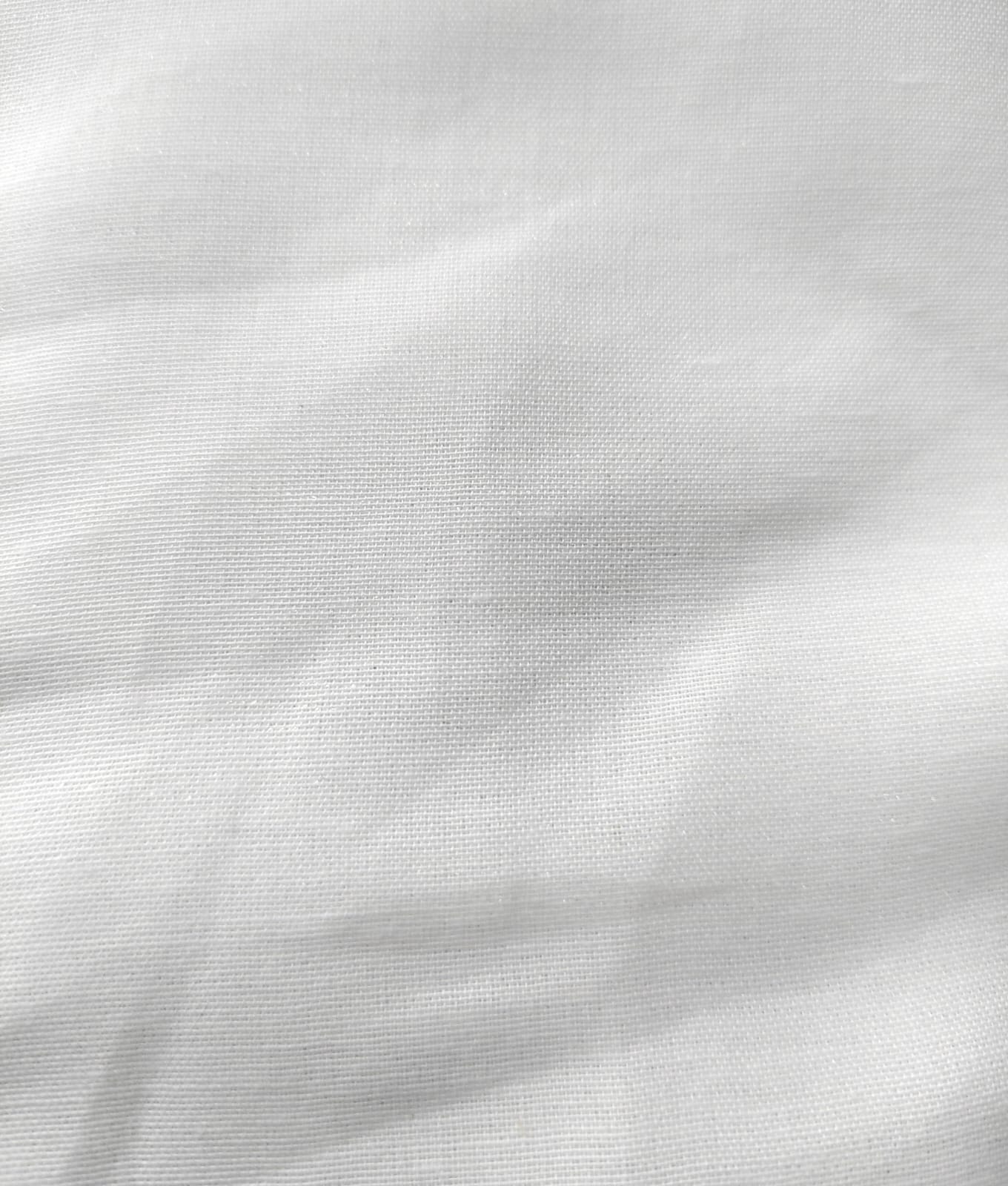 Close-up of soft, wrinkled pink cotton fabric displaying fine weave texture.