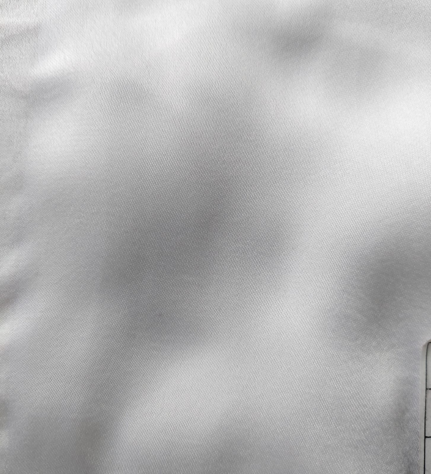 Close-up of soft, wrinkled pink cotton fabric displaying fine weave texture.