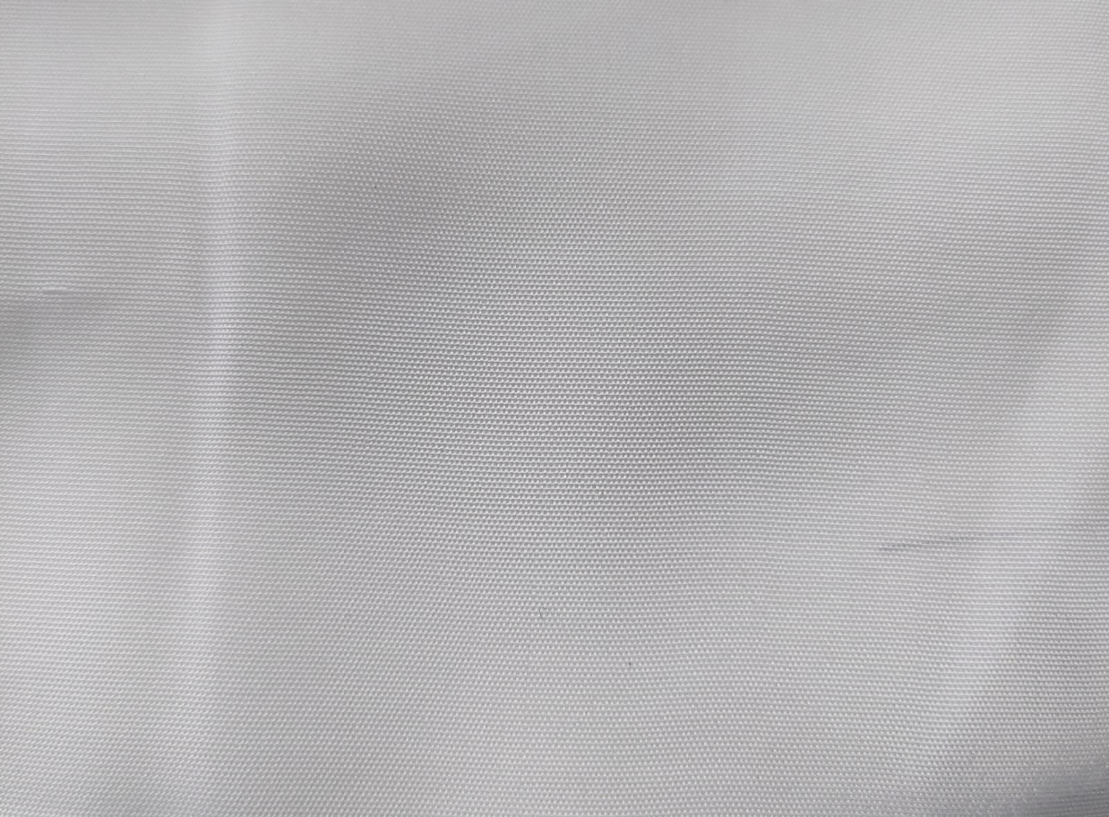 Close-up of soft, wrinkled pink cotton fabric displaying fine weave texture.