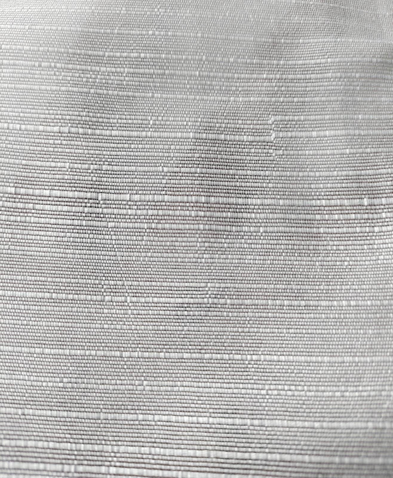 Close-up of soft, wrinkled pink cotton fabric displaying fine weave texture.