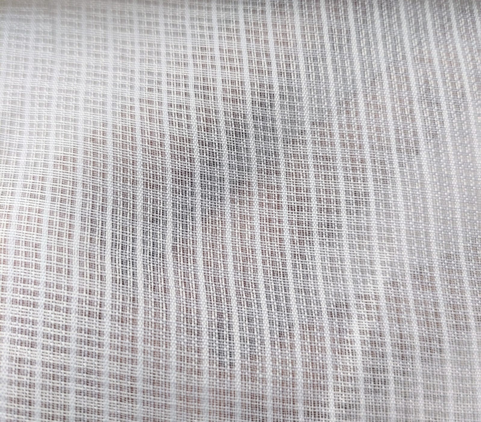 Close-up of soft, wrinkled pink cotton fabric displaying fine weave texture.