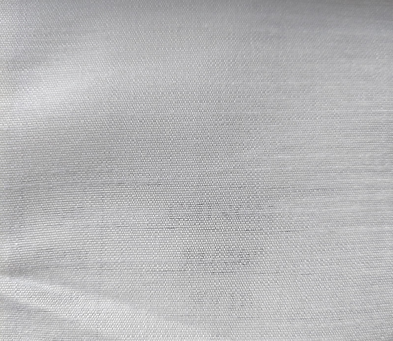 Close-up of soft, wrinkled pink cotton fabric displaying fine weave texture.