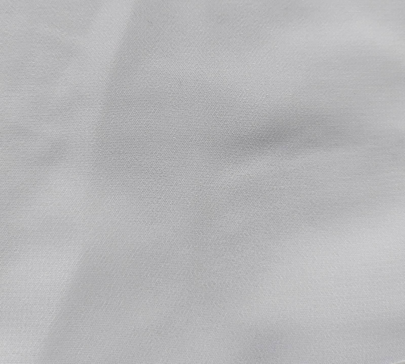 Close-up of soft, wrinkled pink cotton fabric displaying fine weave texture.