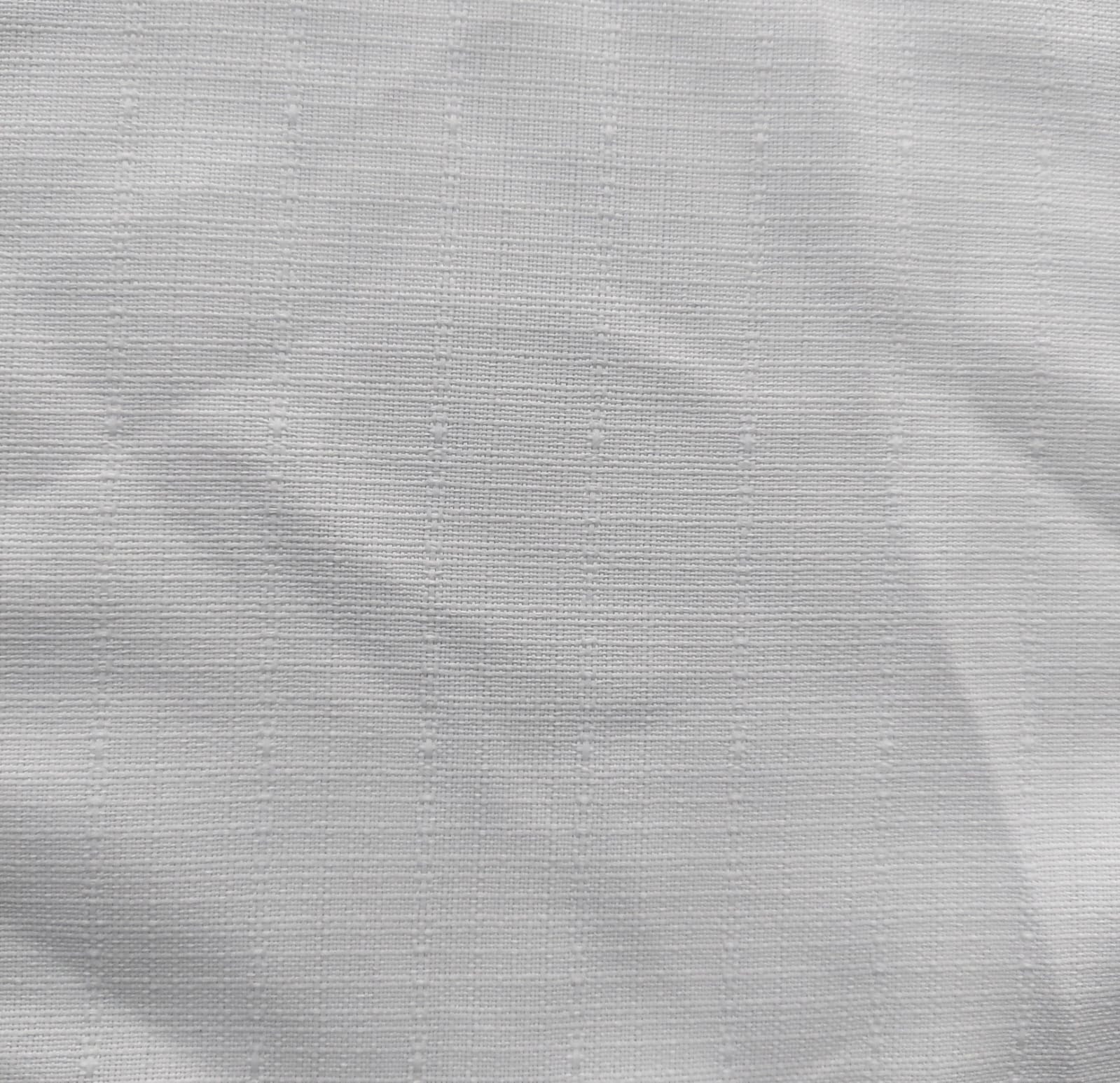 Close-up of soft, wrinkled pink cotton fabric displaying fine weave texture.