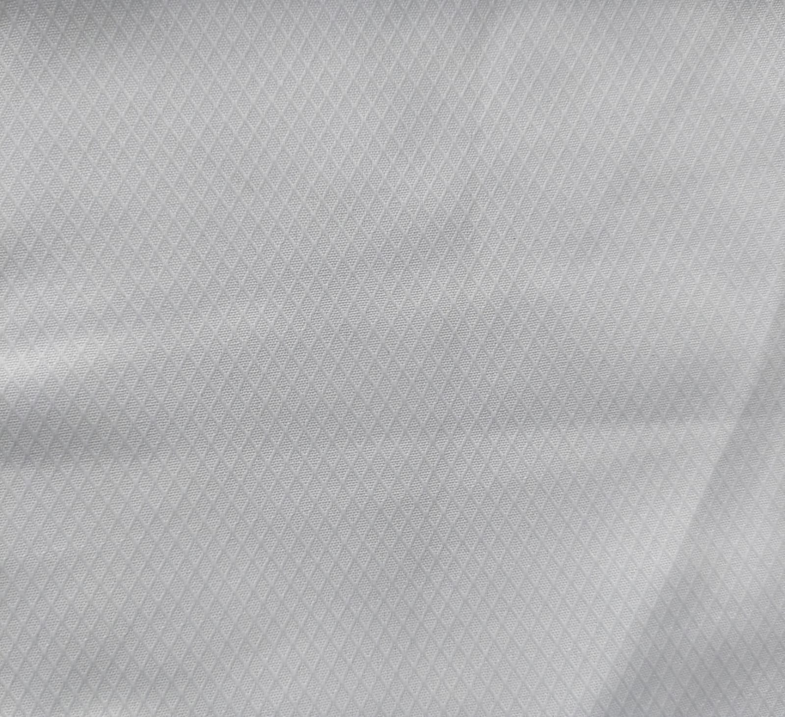Close-up of soft, wrinkled pink cotton fabric displaying fine weave texture.