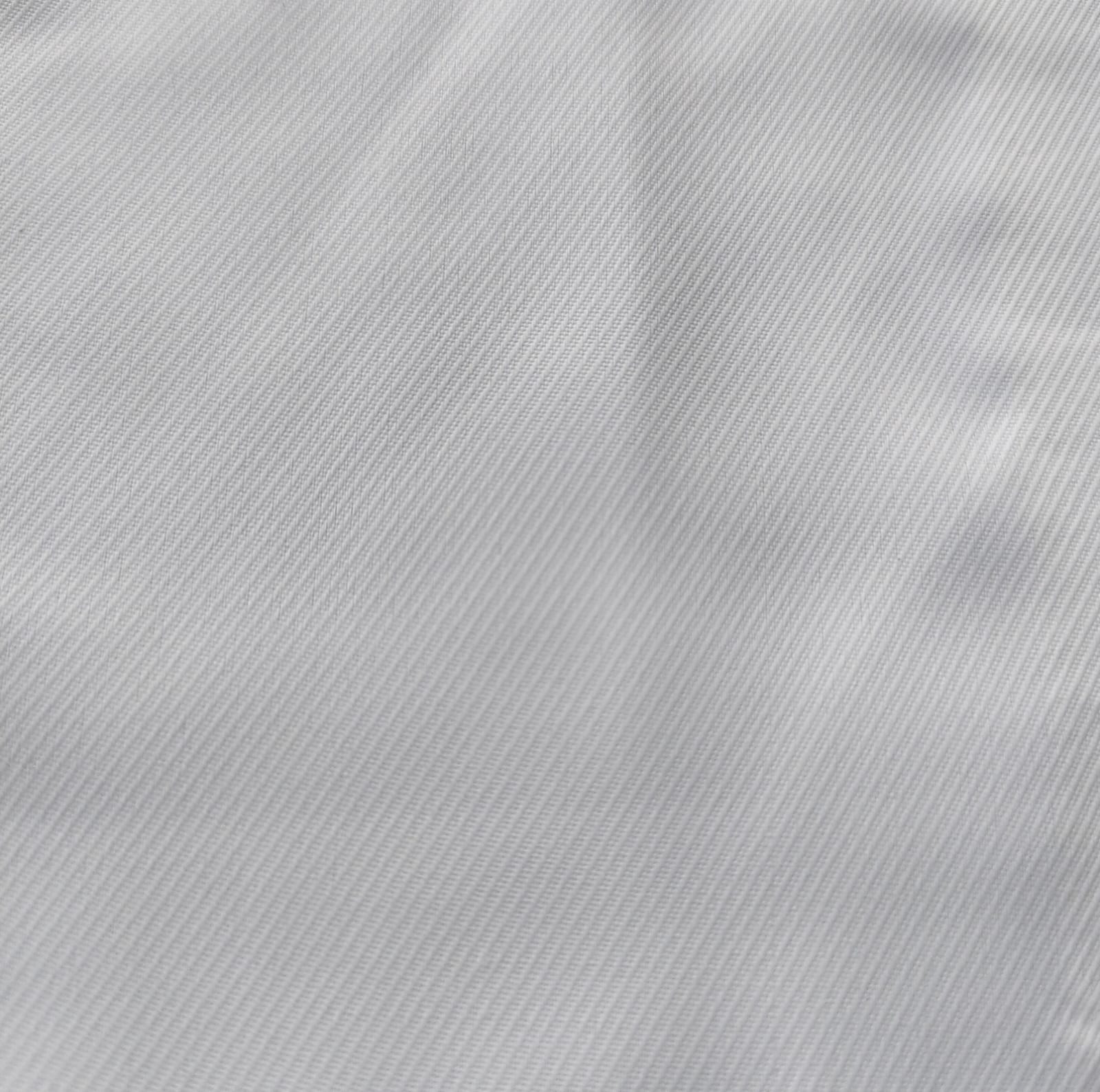 Close-up of soft, wrinkled pink cotton fabric displaying fine weave texture.