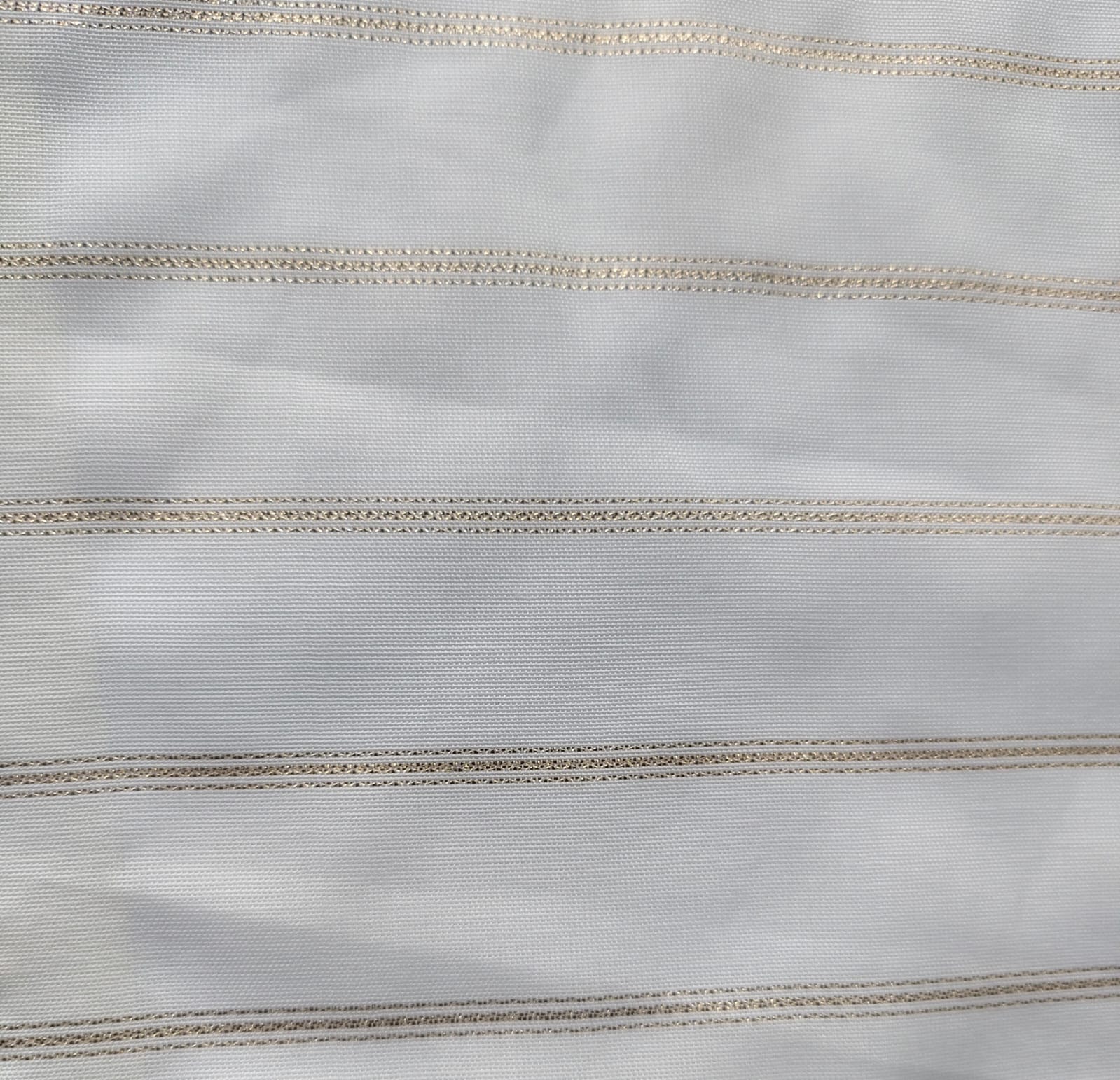Close-up of soft, wrinkled pink cotton fabric displaying fine weave texture.
