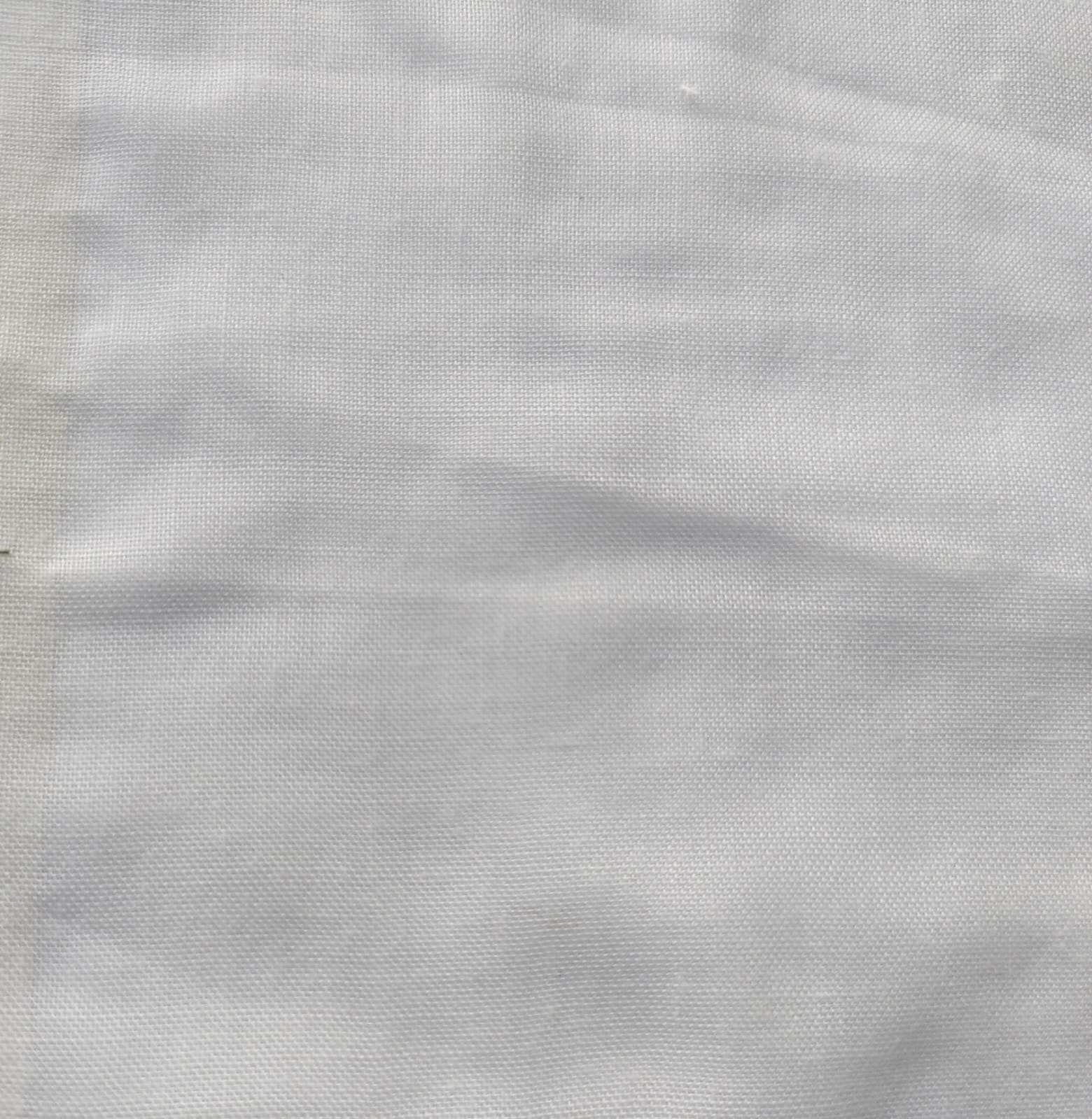 Close-up of soft, wrinkled pink cotton fabric displaying fine weave texture.