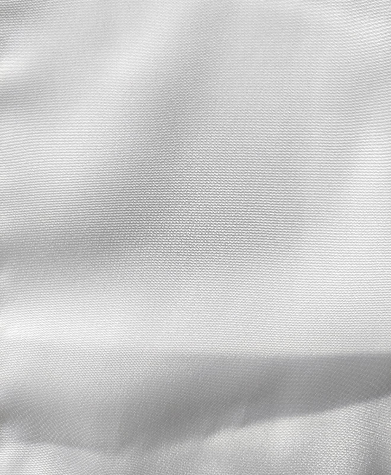 Close-up of soft, wrinkled pink cotton fabric displaying fine weave texture.
