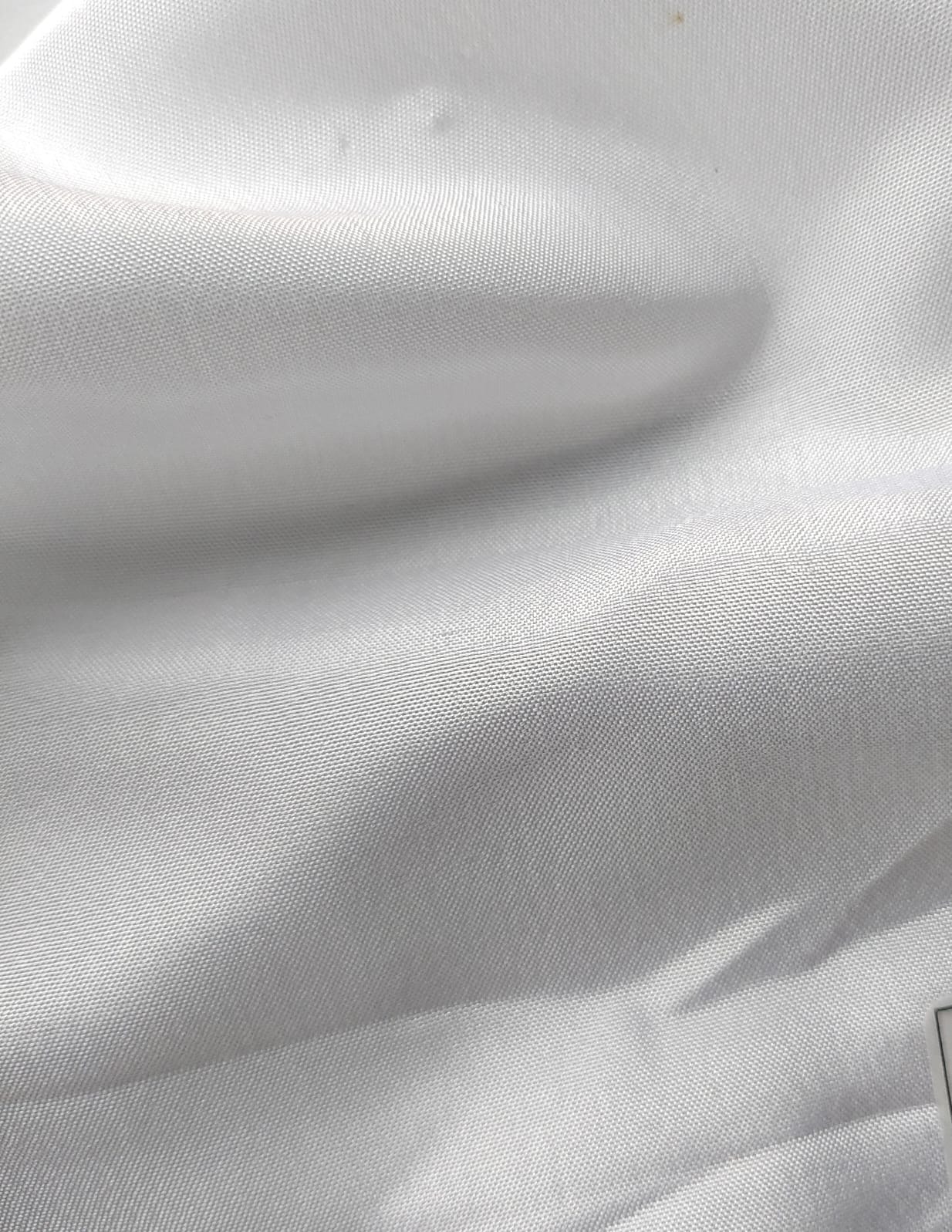 Close-up of soft, wrinkled pink cotton fabric displaying fine weave texture.