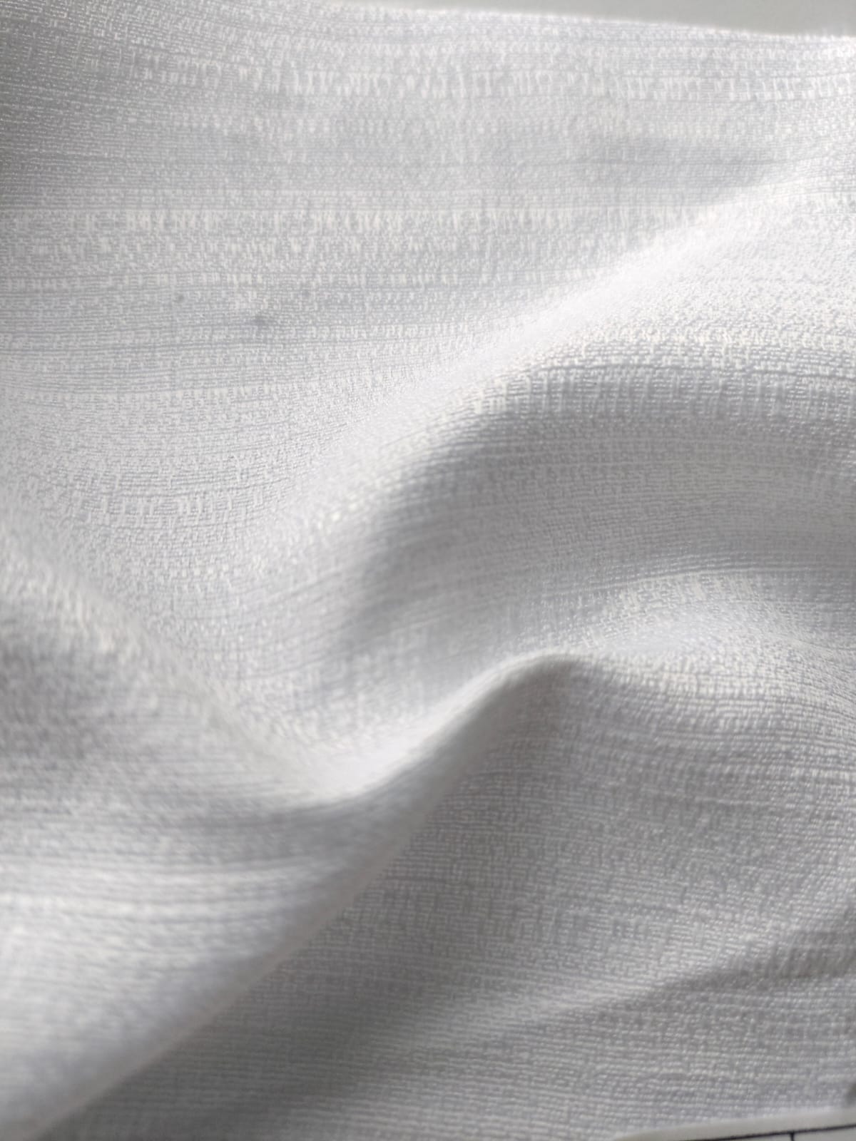Close-up of soft, wrinkled pink cotton fabric displaying fine weave texture.