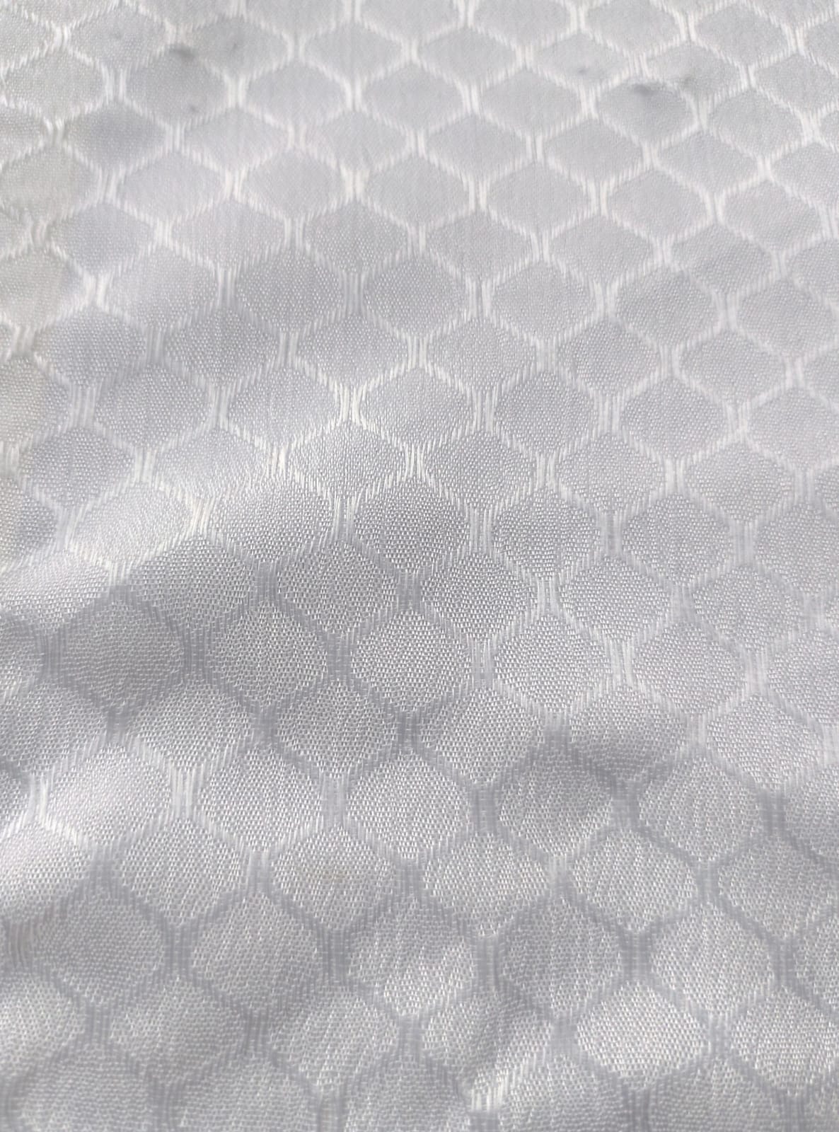 Close-up of soft, wrinkled pink cotton fabric displaying fine weave texture.