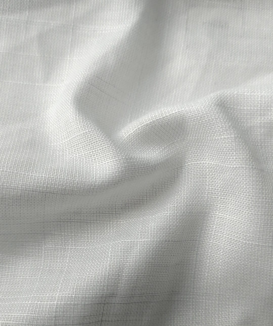 Close-up of soft, wrinkled pink cotton fabric displaying fine weave texture.