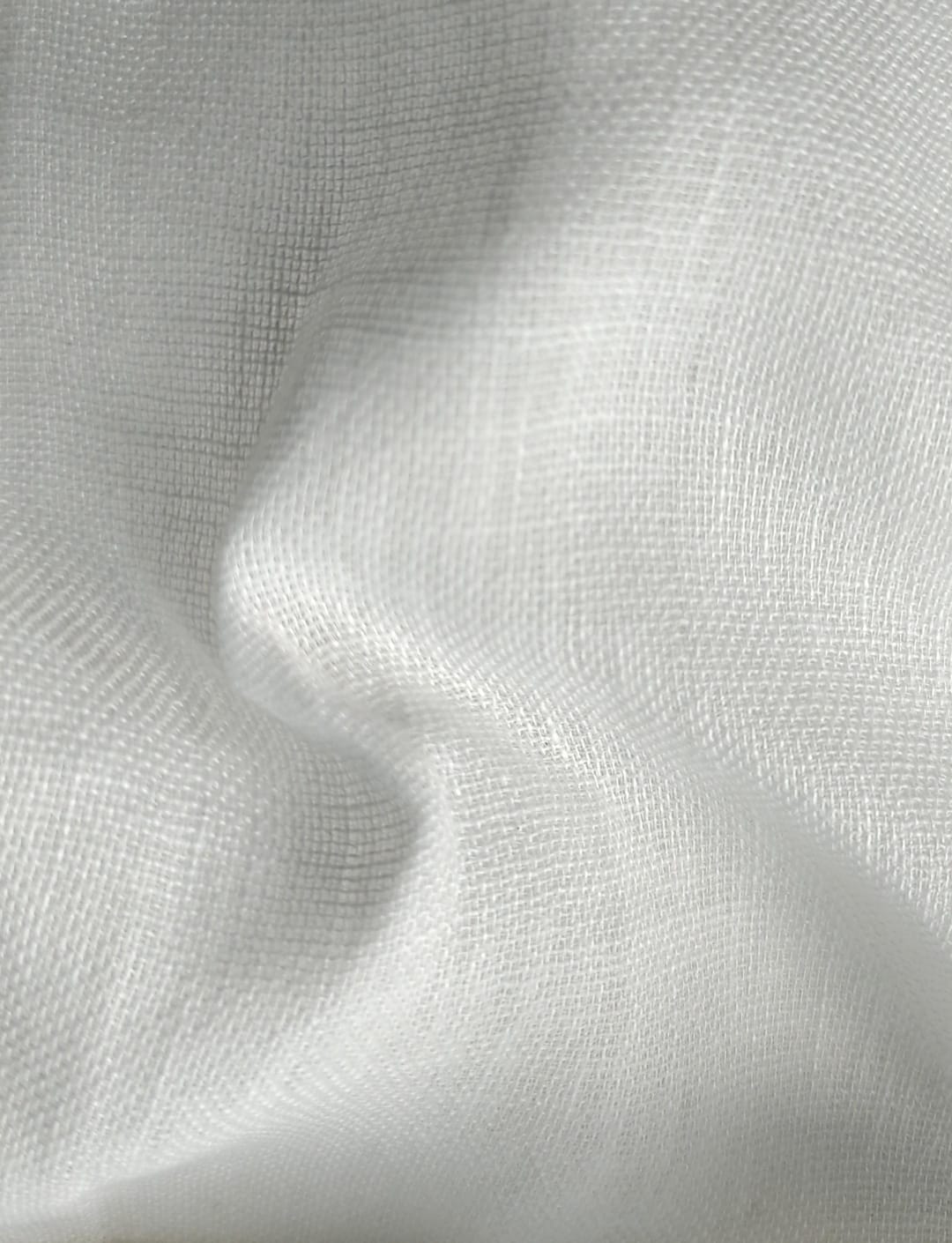 Close-up of soft, wrinkled pink cotton fabric displaying fine weave texture.