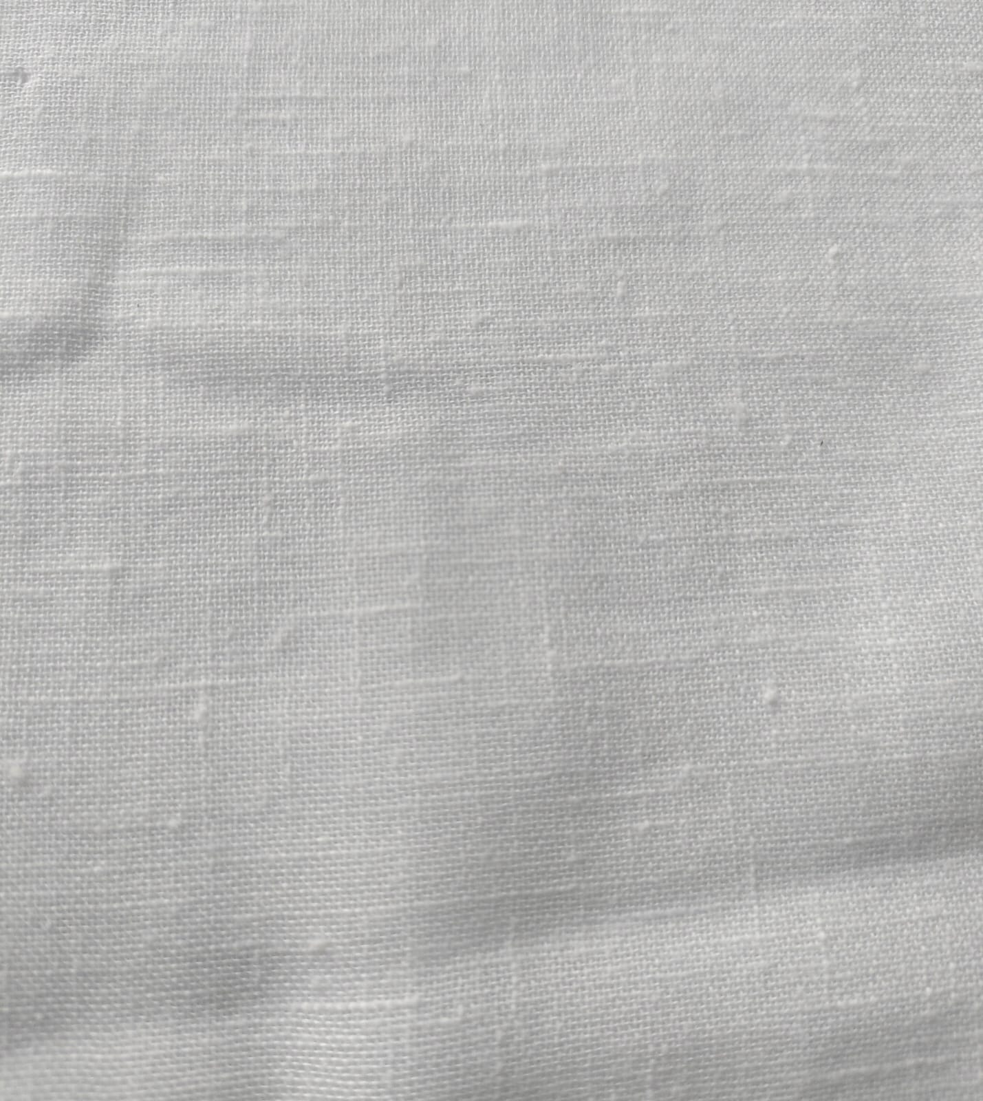 Close-up of soft, wrinkled pink cotton fabric displaying fine weave texture.