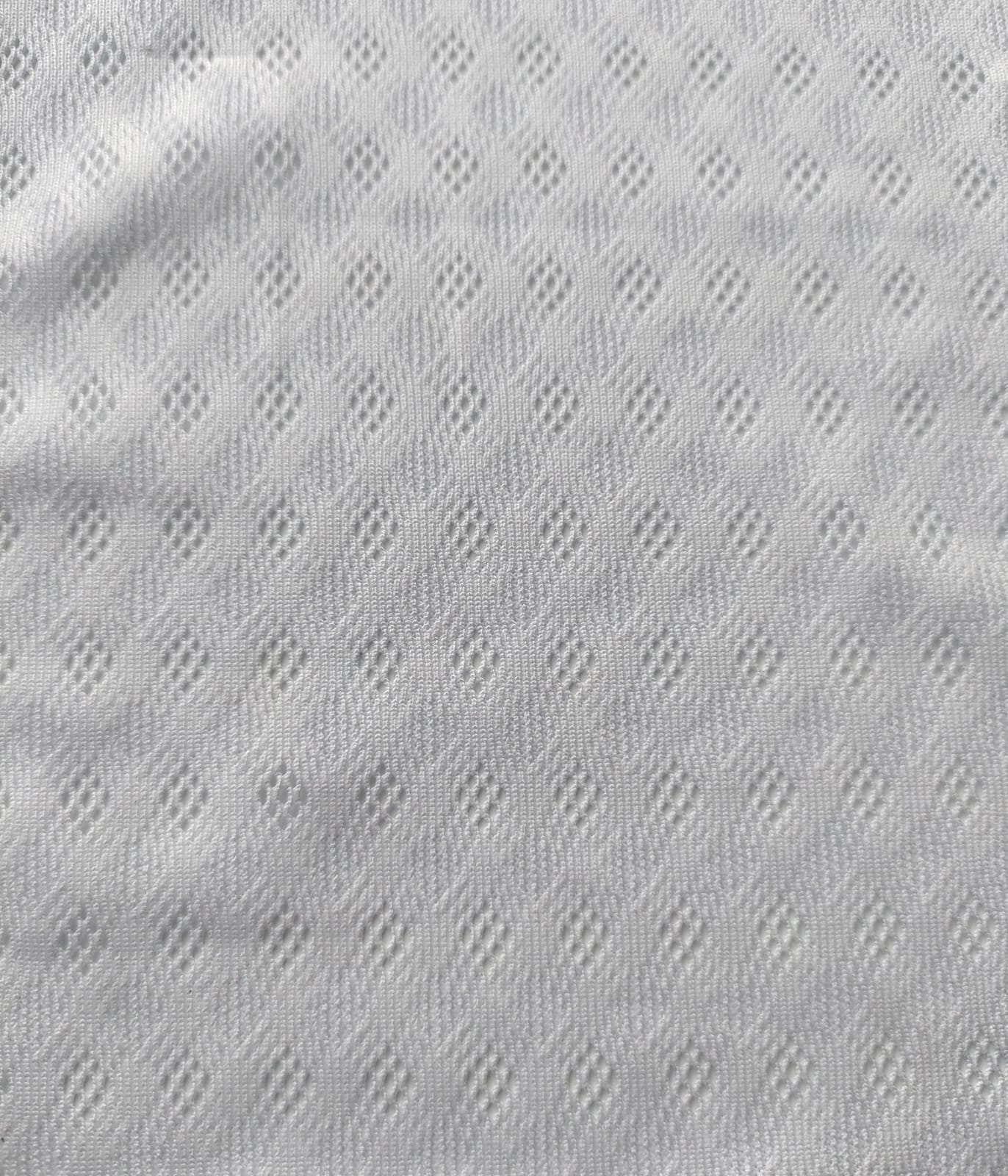 Close-up of soft, wrinkled pink cotton fabric displaying fine weave texture.