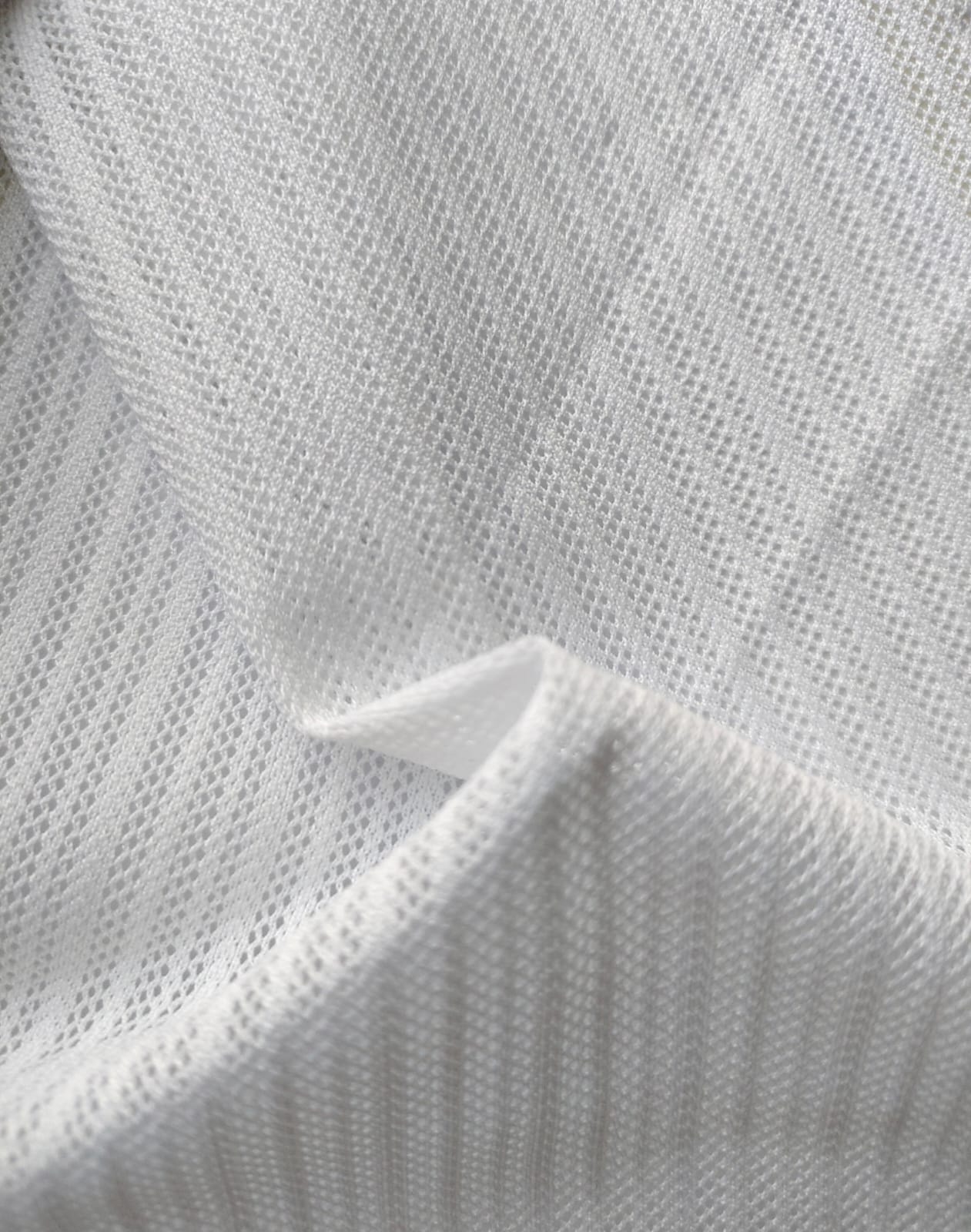 Close-up of soft, wrinkled pink cotton fabric displaying fine weave texture.