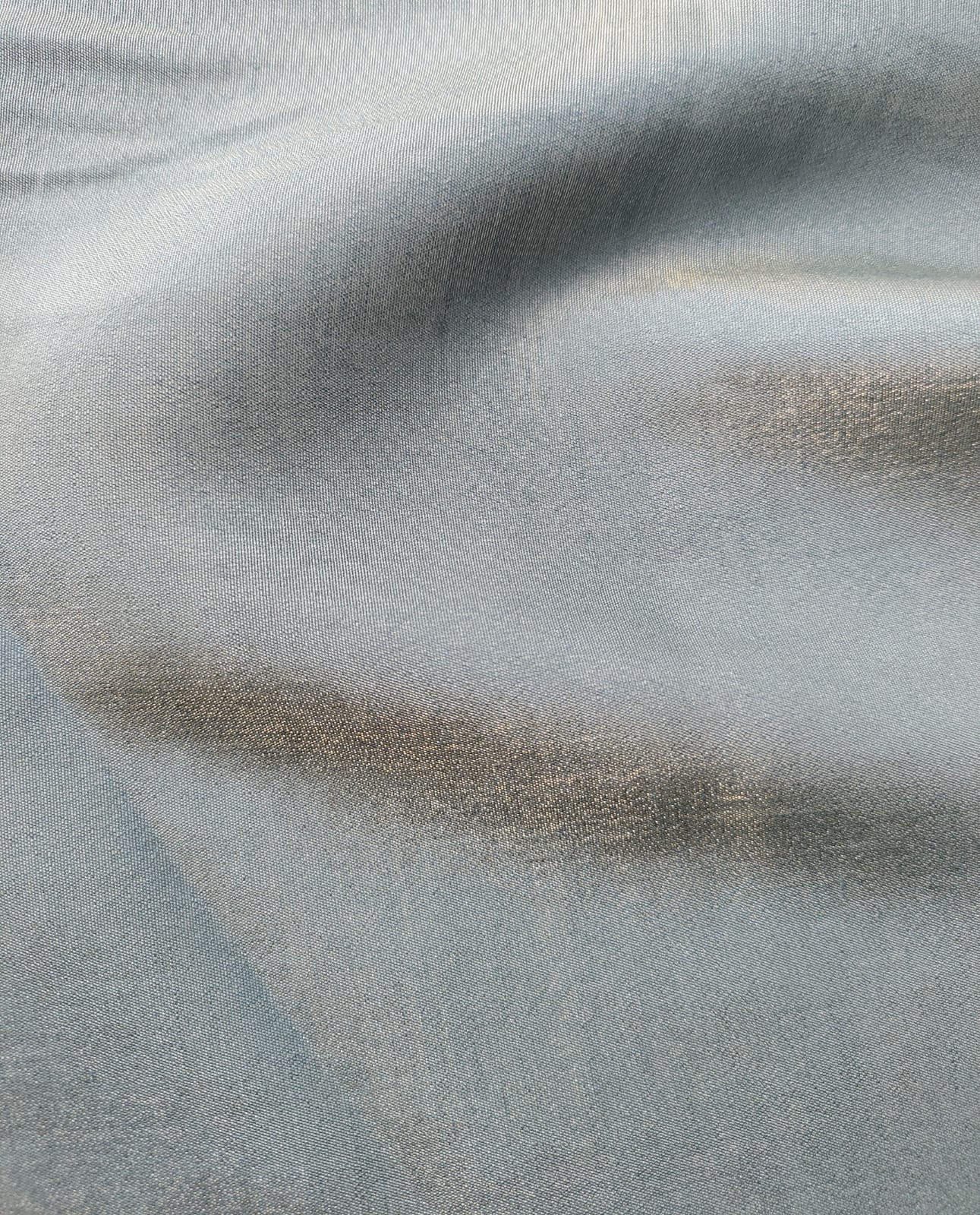 Close-up of soft, wrinkled pink cotton fabric displaying fine weave texture.