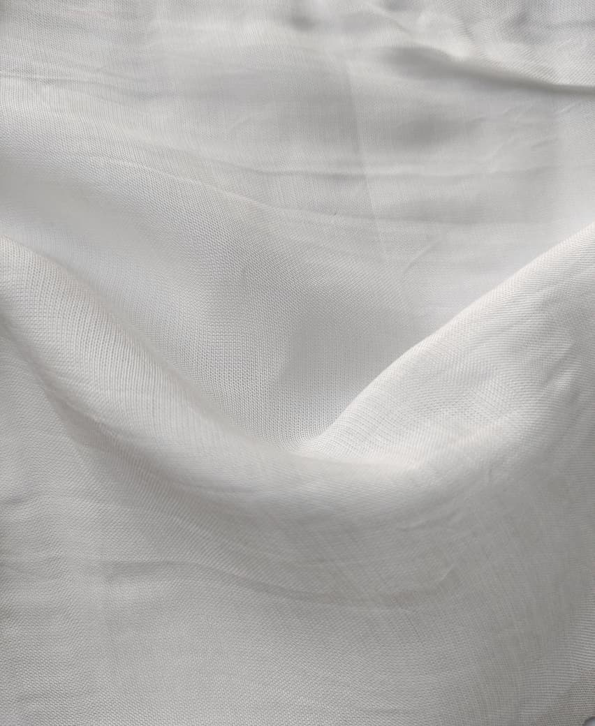 Close-up of soft, wrinkled pink cotton fabric displaying fine weave texture.