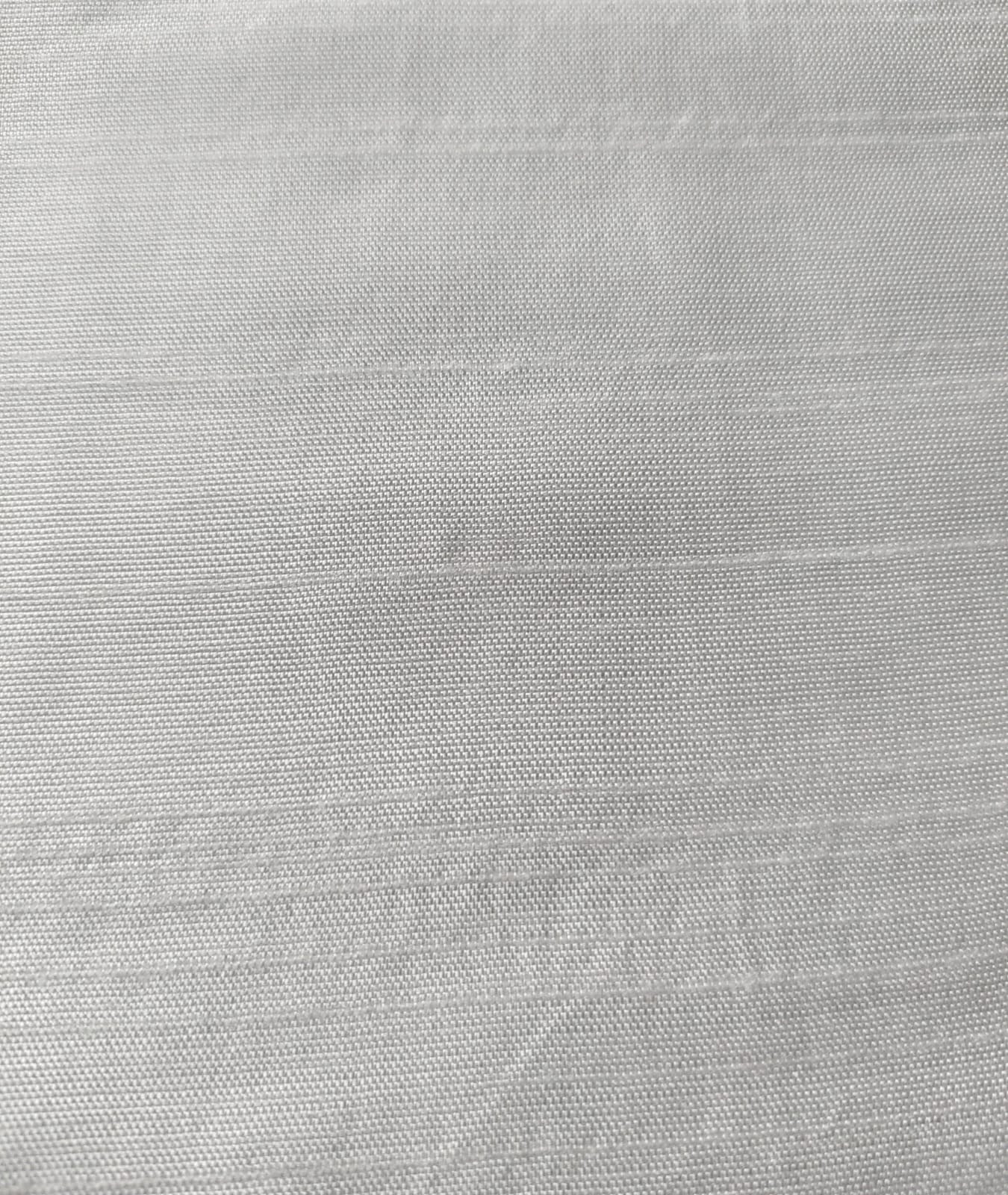 Close-up of soft, wrinkled pink cotton fabric displaying fine weave texture.