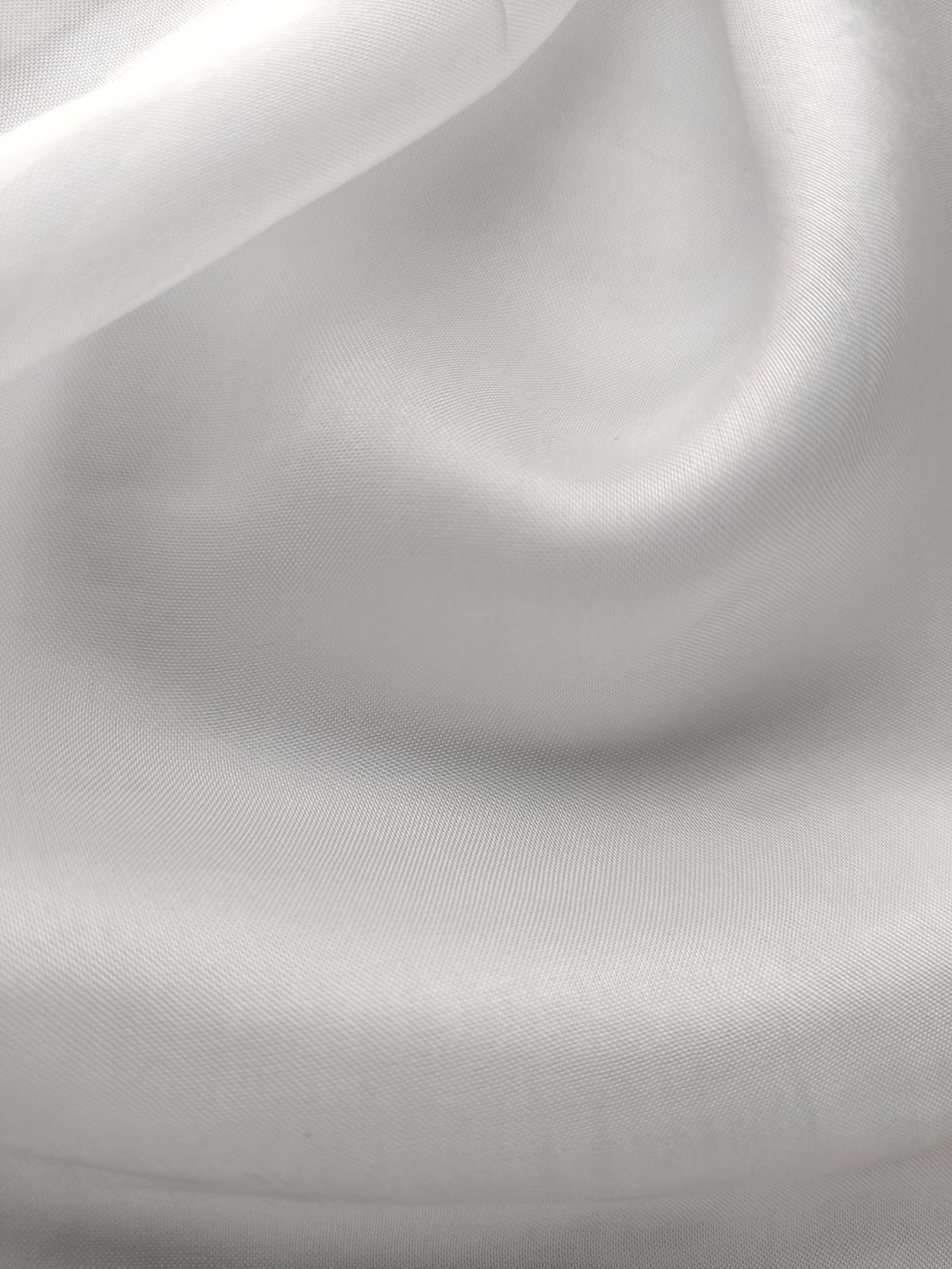 Close-up of soft, wrinkled pink cotton fabric displaying fine weave texture.