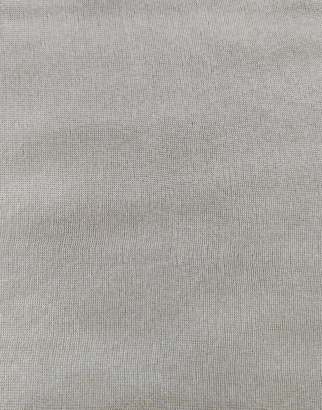 Close-up of soft, wrinkled pink cotton fabric displaying fine weave texture.