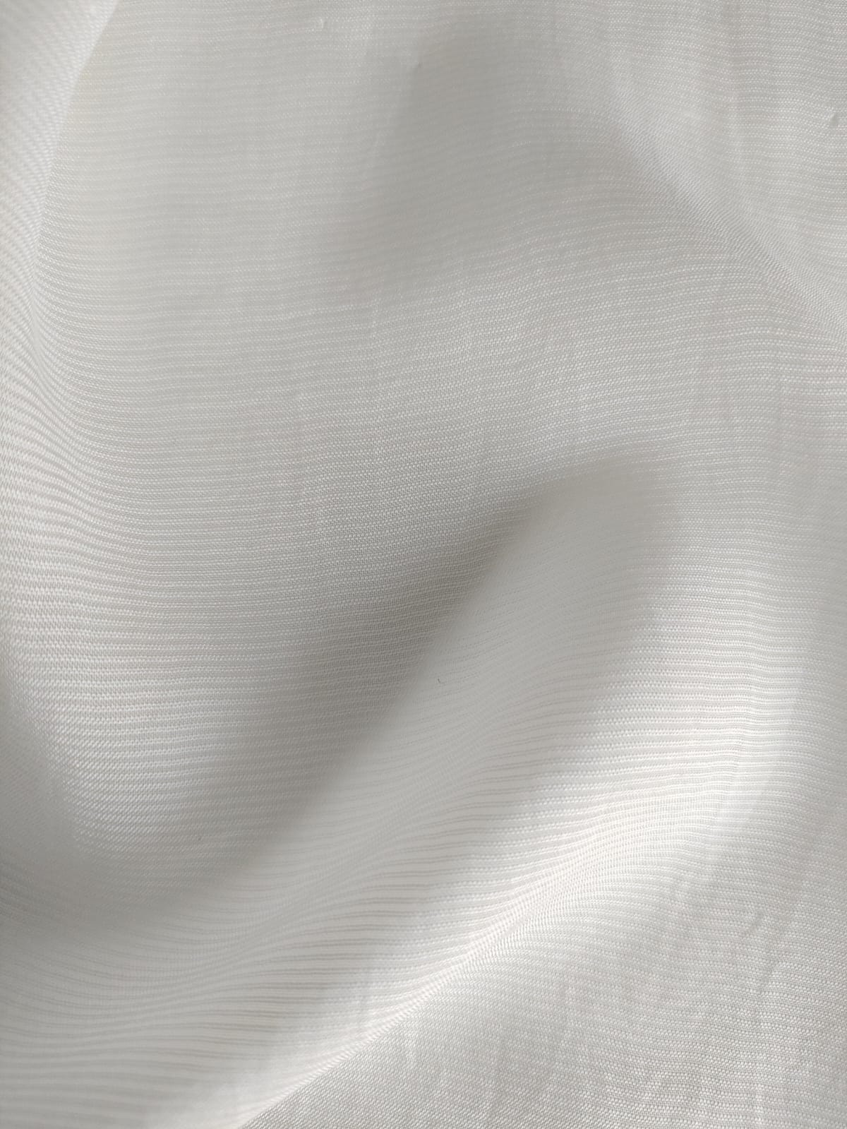 Close-up of soft, wrinkled pink cotton fabric displaying fine weave texture.