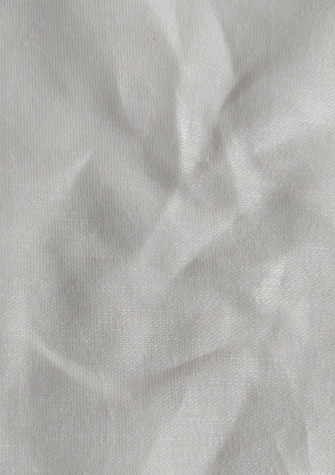 Close-up of soft, wrinkled pink cotton fabric displaying fine weave texture.