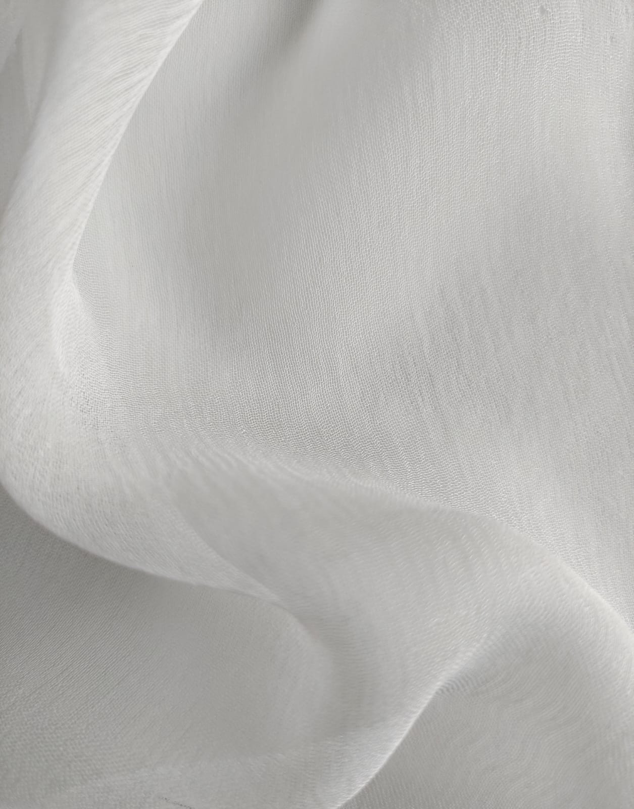 Close-up of soft, wrinkled pink cotton fabric displaying fine weave texture.