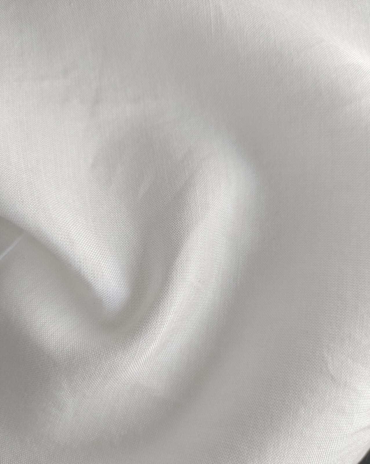 Close-up of soft, wrinkled pink cotton fabric displaying fine weave texture.