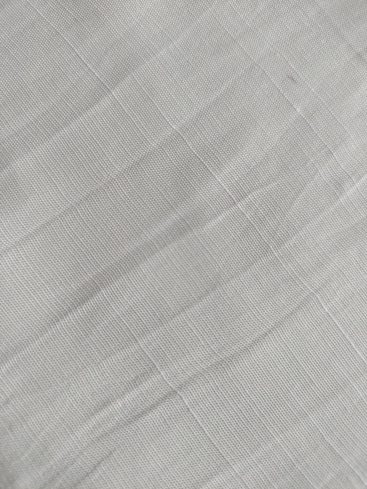 Close-up of soft, wrinkled pink cotton fabric displaying fine weave texture.