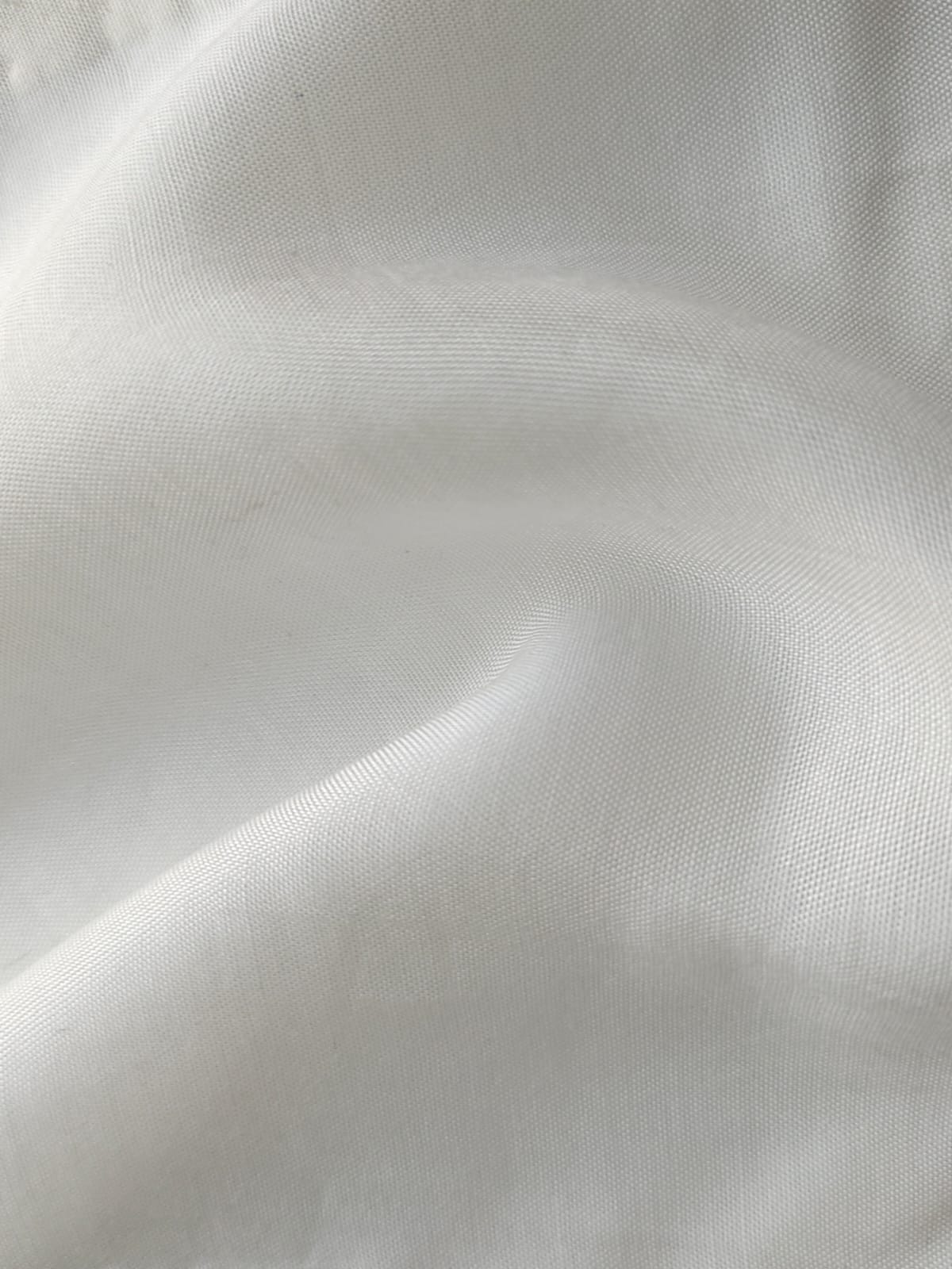 Close-up of soft, wrinkled pink cotton fabric displaying fine weave texture.