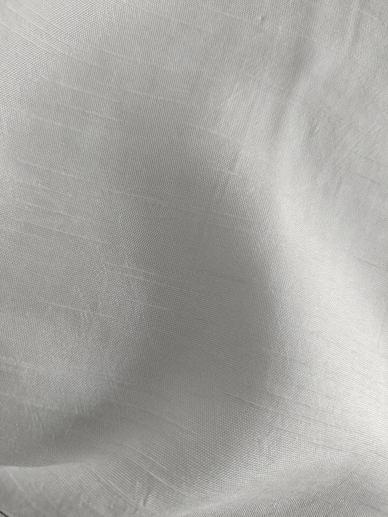 Close-up of soft, wrinkled pink cotton fabric displaying fine weave texture.