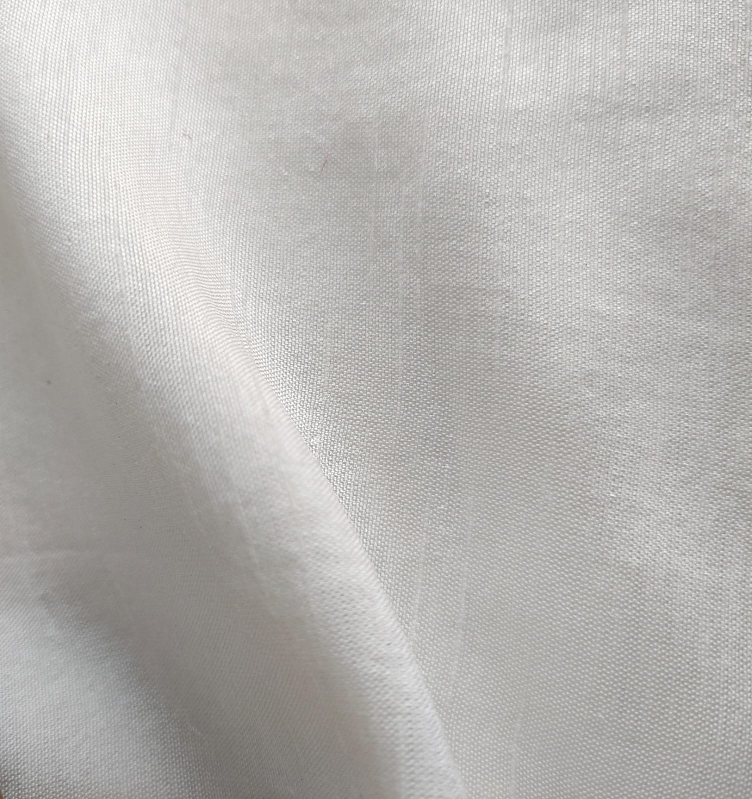 Close-up of soft, wrinkled pink cotton fabric displaying fine weave texture.