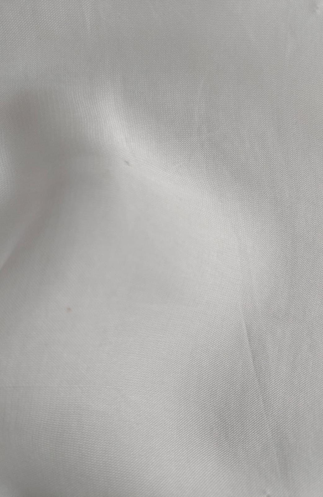 Close-up of soft, wrinkled pink cotton fabric displaying fine weave texture.