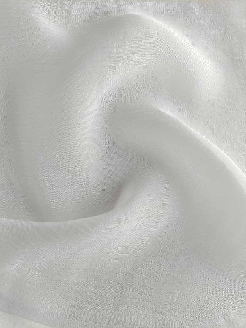Close-up of soft, wrinkled pink cotton fabric displaying fine weave texture.