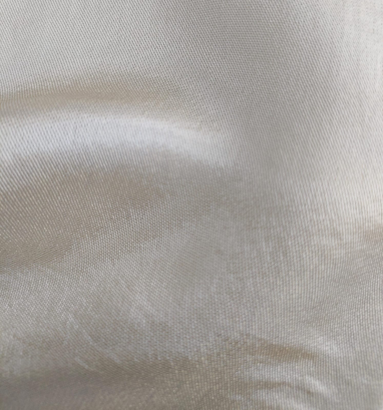 Close-up of soft, wrinkled pink cotton fabric displaying fine weave texture.