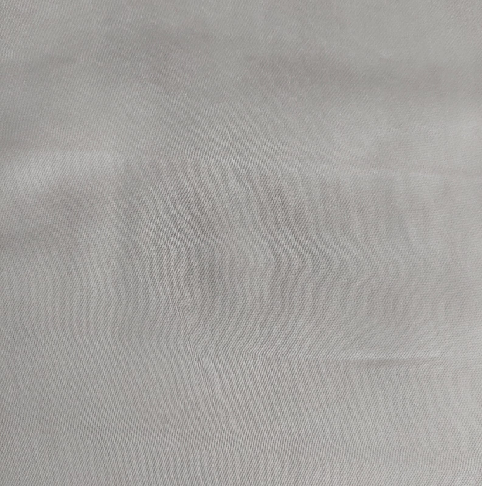 Close-up of soft, wrinkled pink cotton fabric displaying fine weave texture.