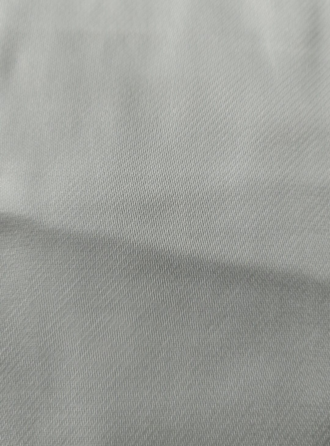 Close-up of soft, wrinkled pink cotton fabric displaying fine weave texture.