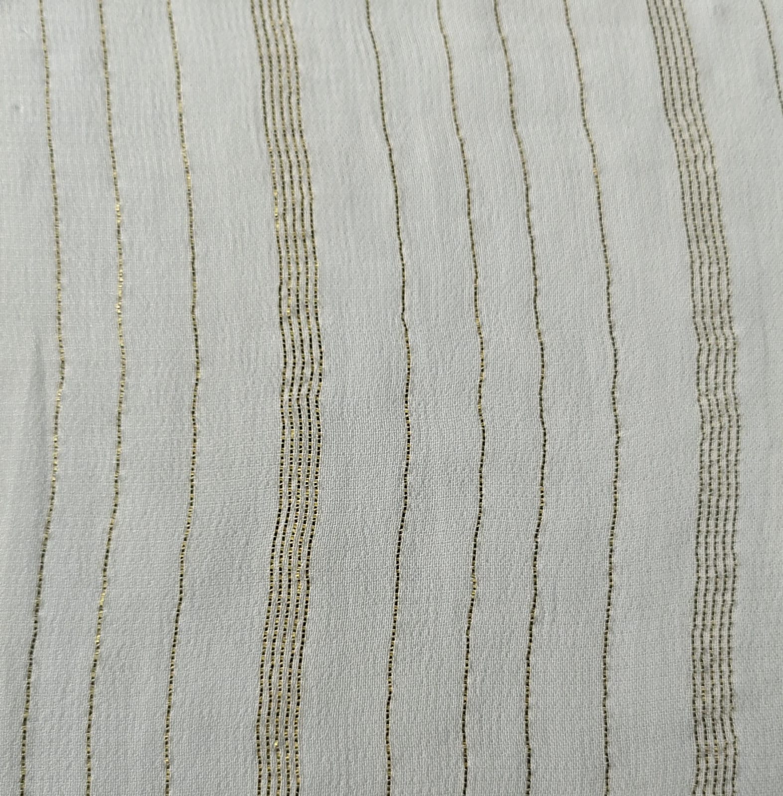 Close-up of soft, wrinkled pink cotton fabric displaying fine weave texture.