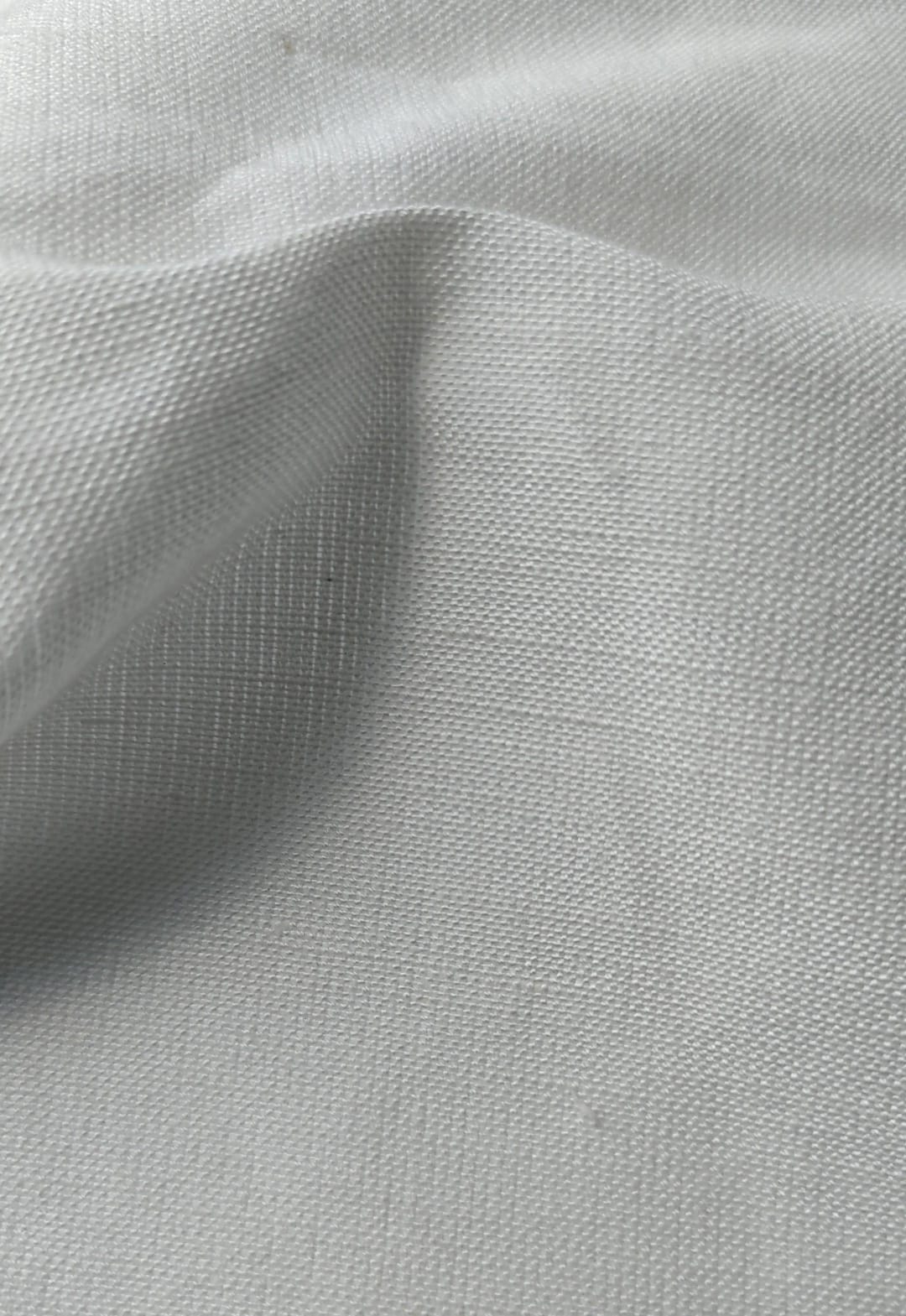 Close-up of soft, wrinkled pink cotton fabric displaying fine weave texture.