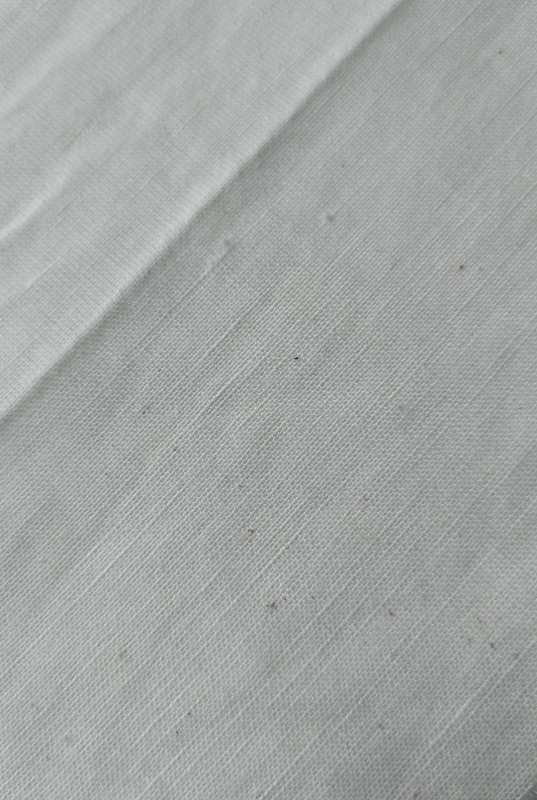 Close-up of soft, wrinkled pink cotton fabric displaying fine weave texture.